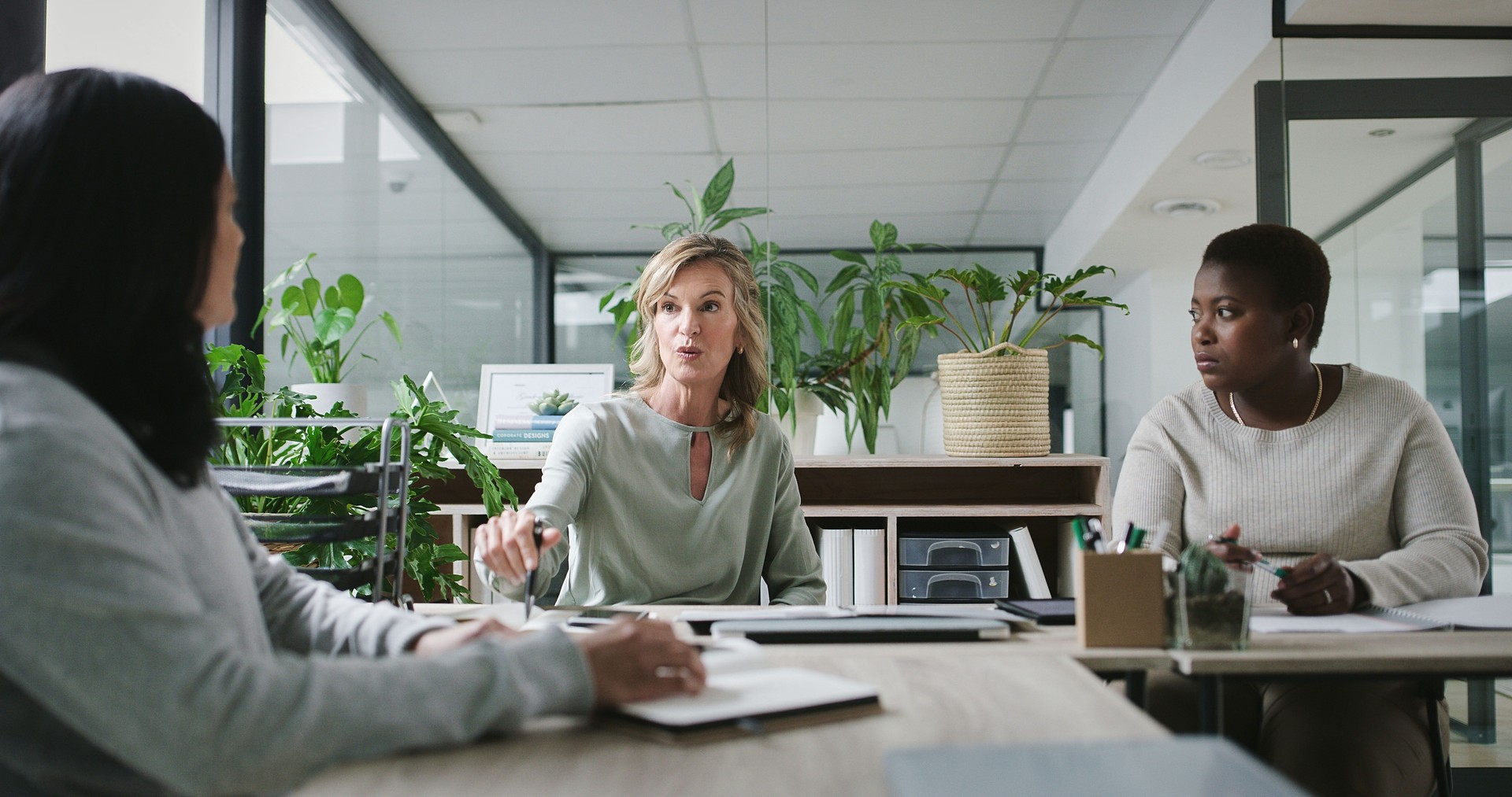 Discussion, teamwork and woman planning for strategy, office and project for brainstorming. Colleagues, employee and conversation for business meeting, communication and brand management agency
